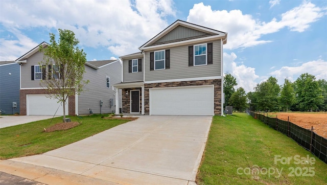 view of front of house with a garage and a front lawn