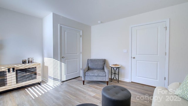 living area with hardwood / wood-style flooring