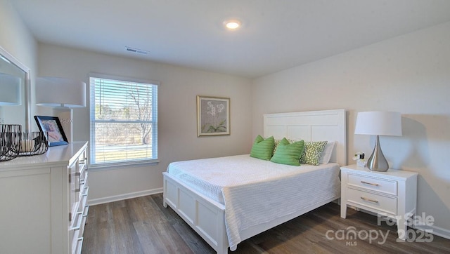 bedroom with dark hardwood / wood-style flooring