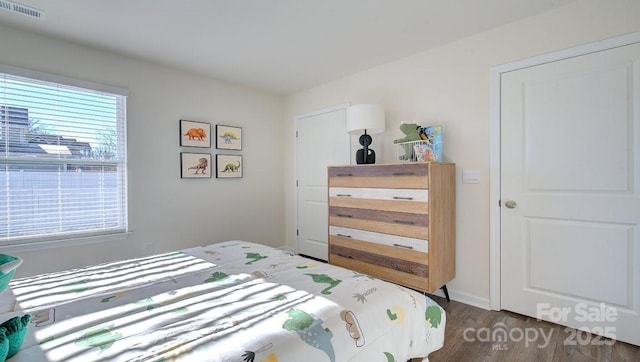 bedroom with dark hardwood / wood-style flooring