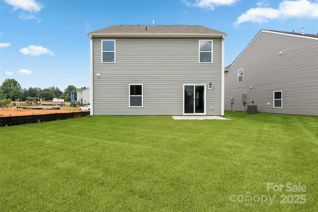 rear view of property with a lawn and central air condition unit