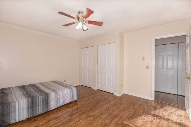 bedroom with dark wood-type flooring and ceiling fan