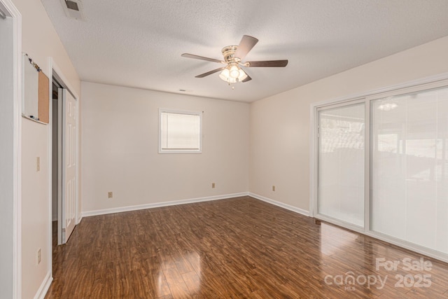 unfurnished bedroom with dark wood-type flooring, ceiling fan, access to exterior, and a textured ceiling