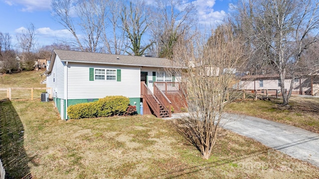 view of front of property with central AC and a front yard