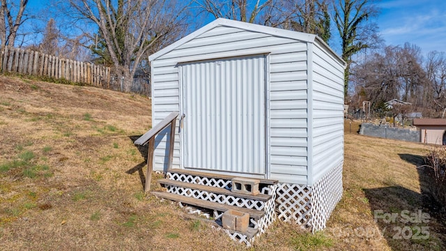 view of outdoor structure featuring a lawn