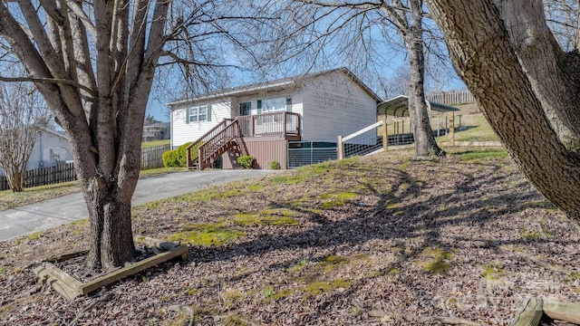 view of front of house with a carport, central AC, and covered porch