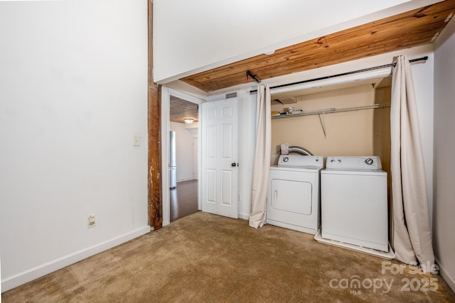 clothes washing area with carpet floors and independent washer and dryer