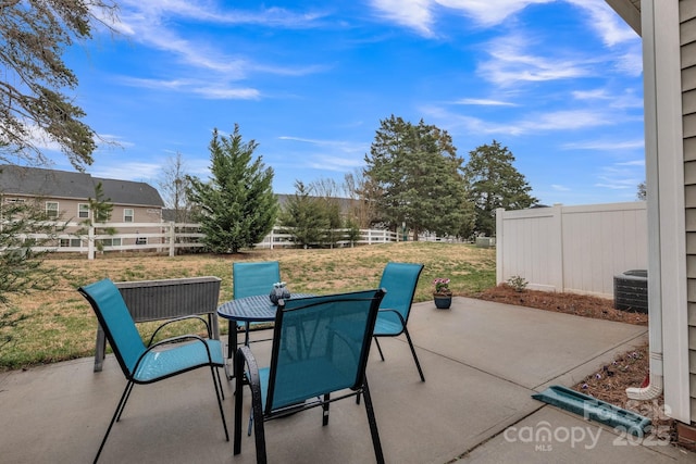 view of patio / terrace featuring outdoor dining space, central AC, and fence