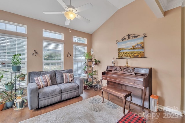 living room featuring lofted ceiling, wood finished floors, baseboards, and ceiling fan