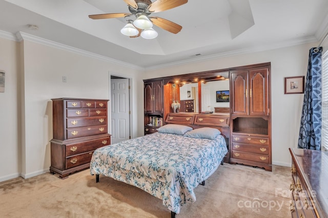 bedroom featuring a raised ceiling, crown molding, light colored carpet, and baseboards