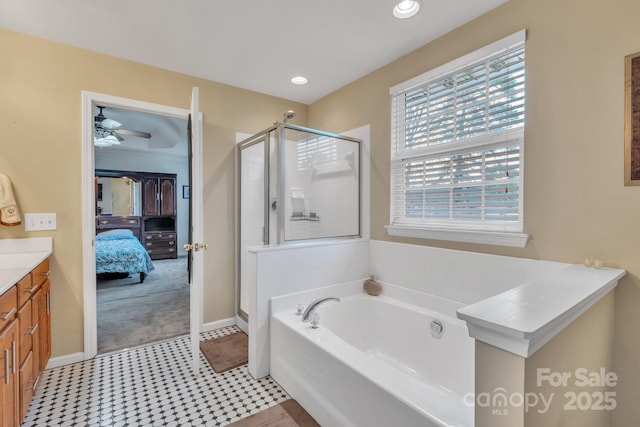 full bath featuring a shower stall, a garden tub, vanity, and connected bathroom