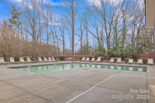 community pool featuring a patio area and fence