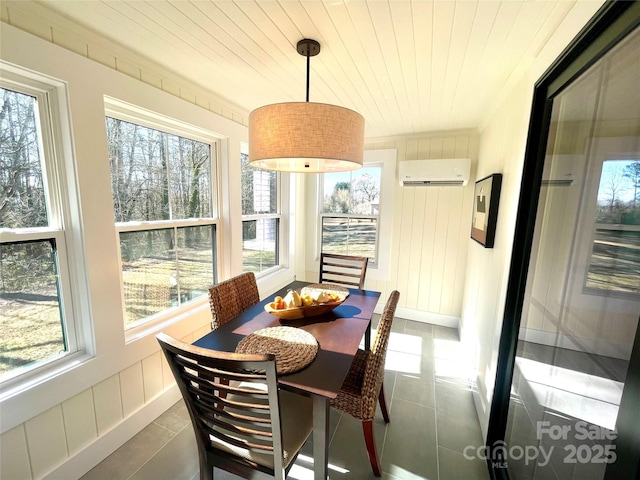 dining area with an AC wall unit, wooden ceiling, and dark tile patterned flooring