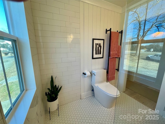 bathroom featuring tile patterned flooring and a healthy amount of sunlight