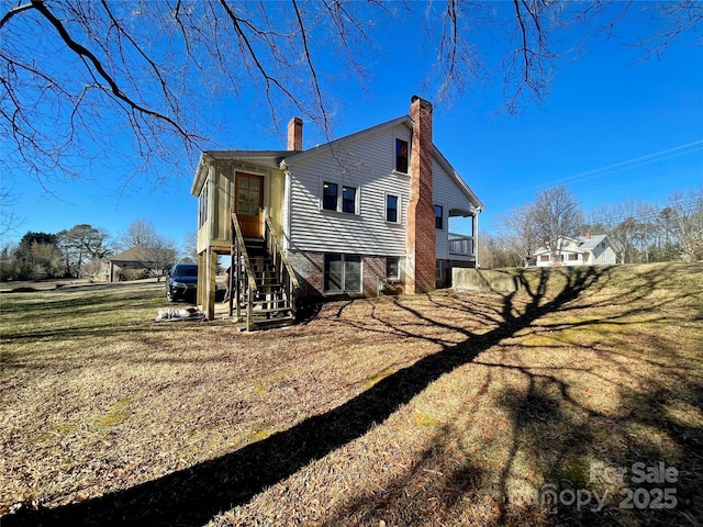 back of house with a lawn