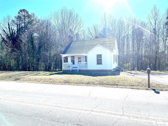 view of front of home with a front yard and covered porch