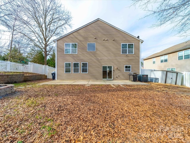 rear view of property featuring cooling unit and a patio area