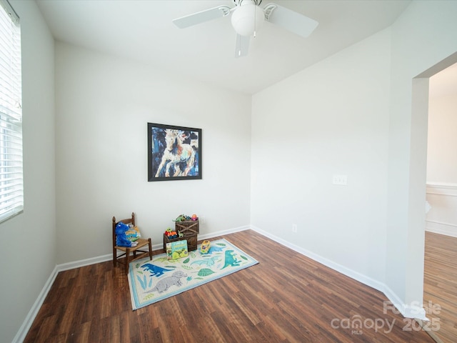 rec room with ceiling fan and dark hardwood / wood-style floors