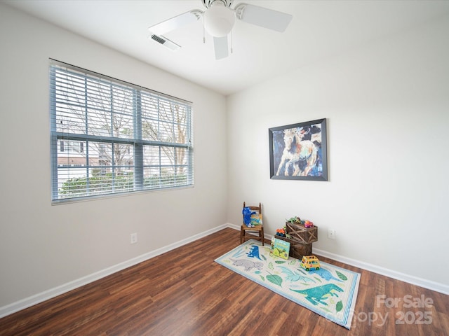 recreation room with dark hardwood / wood-style floors and ceiling fan