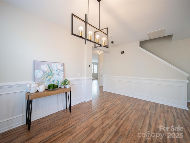 interior space featuring dark hardwood / wood-style flooring and a chandelier