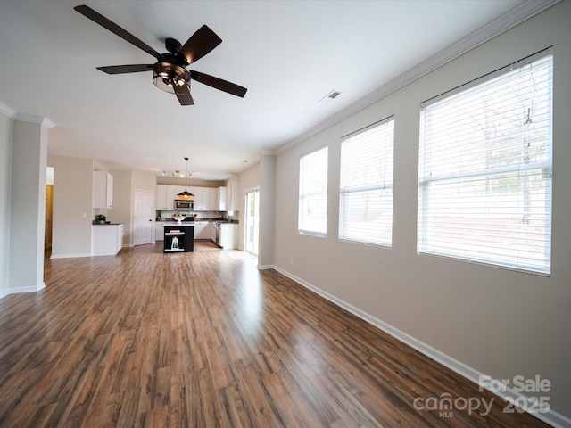 unfurnished living room with ornamental molding, dark wood-type flooring, and ceiling fan