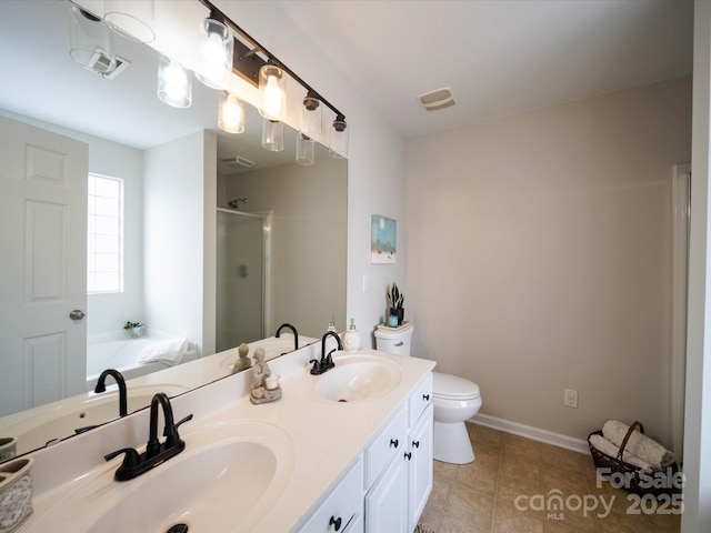 full bathroom featuring toilet, vanity, plus walk in shower, and tile patterned flooring