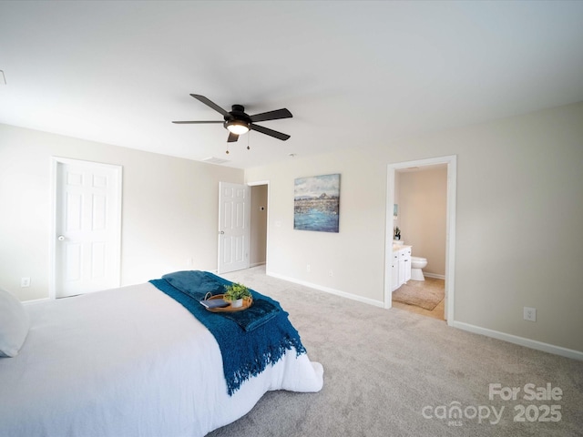 bedroom featuring light carpet, connected bathroom, and ceiling fan