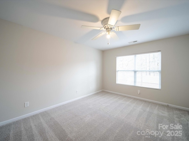 empty room with ceiling fan and carpet