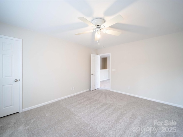 spare room featuring ceiling fan and light colored carpet