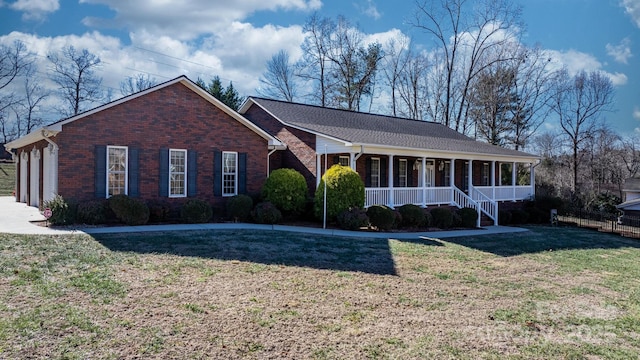 ranch-style house featuring a porch and a front lawn