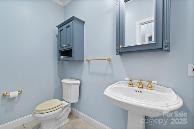 bathroom featuring sink, toilet, and tile patterned flooring