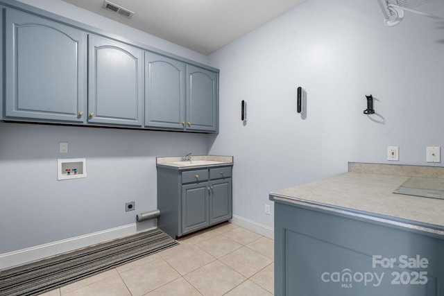 washroom featuring sink, cabinets, light tile patterned floors, hookup for a washing machine, and electric dryer hookup