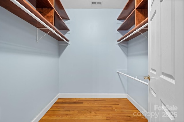 walk in closet featuring hardwood / wood-style floors