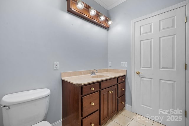 bathroom featuring vanity, crown molding, tile patterned floors, and toilet