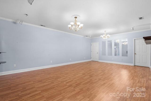 unfurnished room featuring a notable chandelier, crown molding, and light wood-type flooring