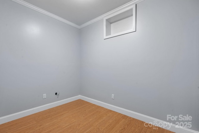 spare room with hardwood / wood-style floors and ornamental molding