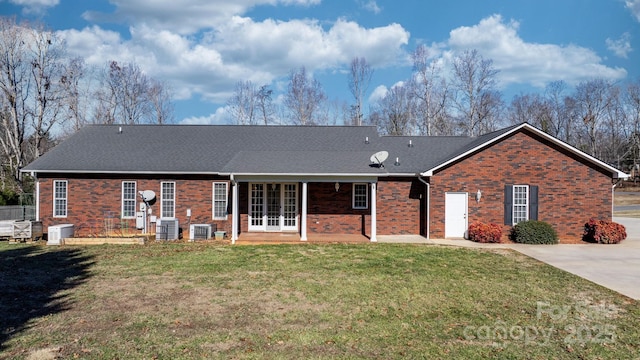 view of front of home featuring a front yard and central air condition unit