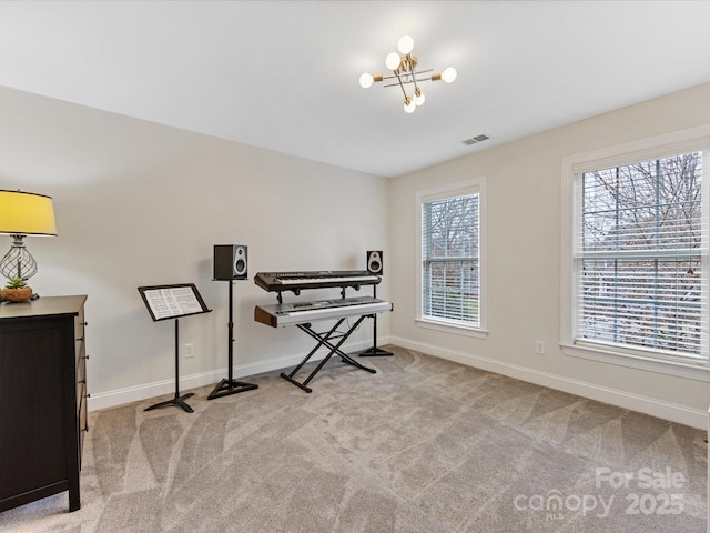 miscellaneous room with light carpet and a chandelier