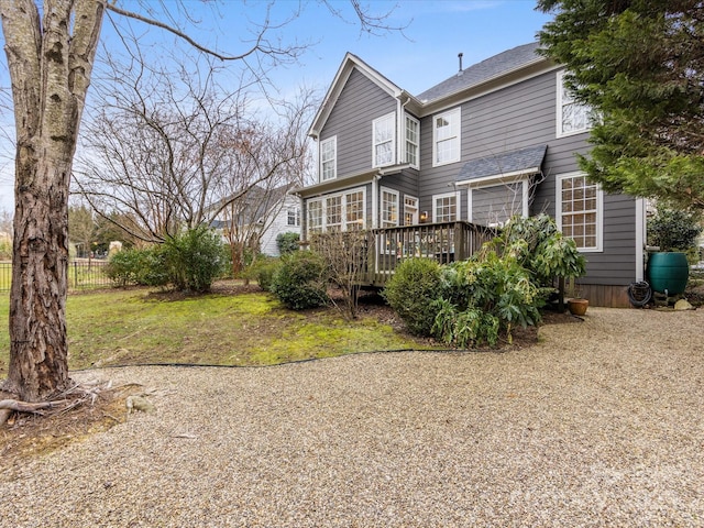 back of property featuring a wooden deck