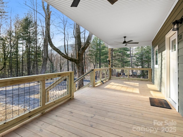 wooden deck featuring ceiling fan