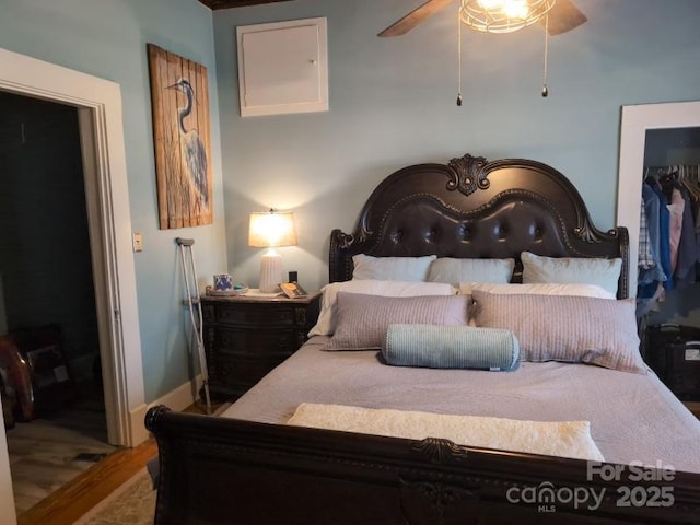 bedroom featuring wood-type flooring, a closet, and ceiling fan