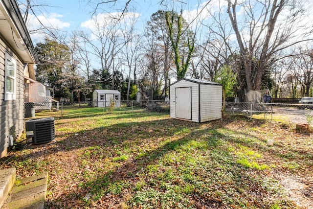 view of yard featuring central AC and a storage shed