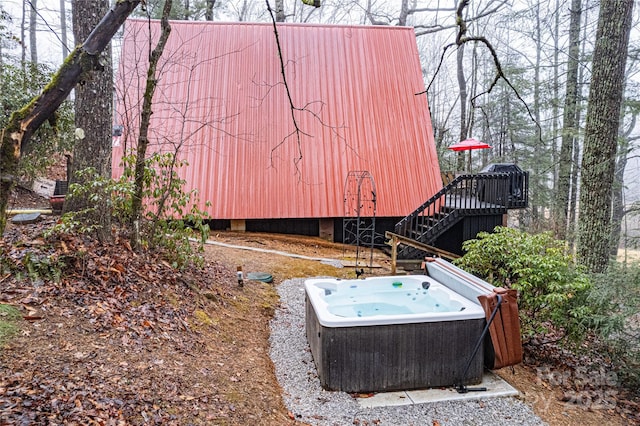 view of yard featuring a wooden deck and a hot tub