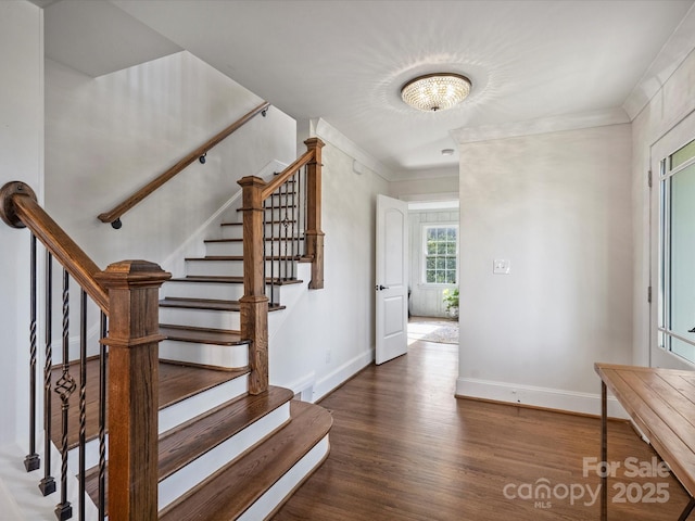 stairs featuring hardwood / wood-style flooring and ornamental molding