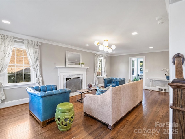 living room with crown molding, dark hardwood / wood-style floors, and a premium fireplace