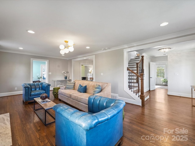 living room featuring crown molding, a chandelier, and dark hardwood / wood-style floors