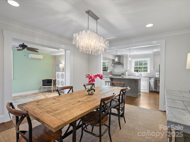 dining area featuring ceiling fan, sink, crown molding, and a wall mounted air conditioner