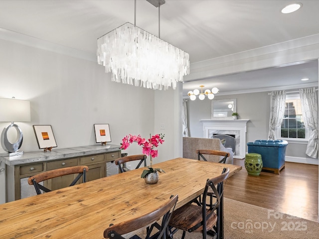 dining room with an inviting chandelier, dark hardwood / wood-style floors, and crown molding