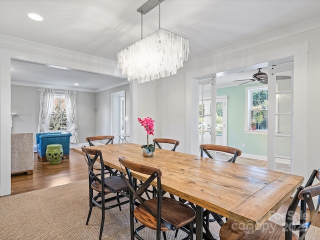 carpeted dining room with a notable chandelier and crown molding