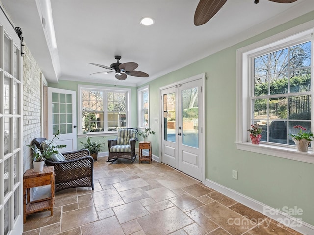 sunroom / solarium with ceiling fan and french doors